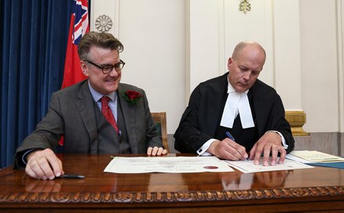 MIKE DEAL / WINNIPEG FREE PRESS
Manitoba Liberal Leader Dougald Lamont is sworn in as an MLA during a ceremony with Deputy Clerk of the Legislative Assembly of Manitoba, Rick Yarish, in the Manitoba Legislative Building Friday afternoon.
180727 - Friday, July 27, 2018.
Deputy Clerk Rick