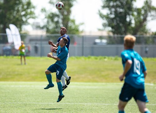 ANDREW RYAN / WINNIPEG FREE PRESS Rovers FC (navy) Damian Rocke (3) and Galacticos FC Pablo Pablete (23) battle in the air for a header in the Men's provincial championship match on July 28, 2018.