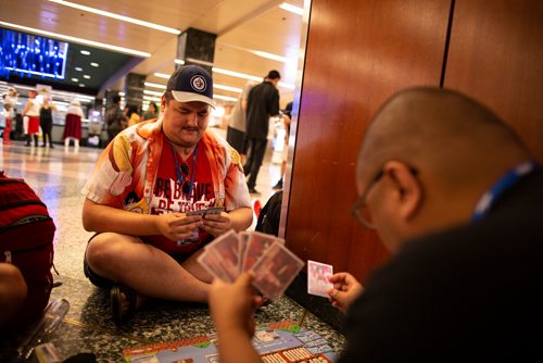ANDREW RYAN / WINNIPEG FREE PRESS Christopher Schmidt plays cards with friend Jeremy Santos while waiting in line for a guest Q&A during the Ai-Kon Anime Convention at the RBC Convention Centre on July 28, 2018.