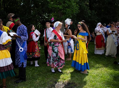 ANDREW RYAN / WINNIPEG FREE PRESS Sophia Rivera, representing Brazil (yellow), and Cynthia vanDriel, representing Belgium, discuss their upcoming speeches at the Folklorama Kickoff party in Assinaboine Park on July 28, 2018.