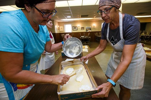 MIKE DEAL / WINNIPEG FREE PRESS
Hilda Terry (left) and Alenia Howell (right) add a final layer of cream filling to the lemon torte in the basement of the Our Lady of Lourdes church at 95 MacDonald Ave. where volunteers are baking huge lemon tortes for the Slovenian pavilion which makes all their own food for Folklorama.
180721 - Saturday, July 21, 2018.