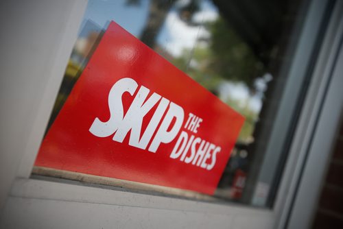 JOHN WOODS / WINNIPEG FREE PRESS
Signs of Skip The Dishes, the food delivery service, stick to restaurant windows in Winnipeg Monday, July 30, 2018. The service provided is having labour issues.