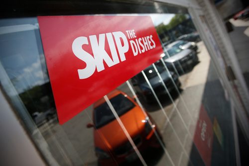 JOHN WOODS / WINNIPEG FREE PRESS
Signs of Skip The Dishes, the food delivery service, stick to restaurant windows in Winnipeg Monday, July 30, 2018. The service provided is having labour issues.