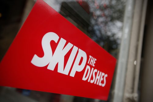 JOHN WOODS / WINNIPEG FREE PRESS
Signs of Skip The Dishes, the food delivery service, stick to restaurant windows in Winnipeg Monday, July 30, 2018. The service provided is having labour issues.