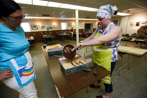 MIKE DEAL / WINNIPEG FREE PRESS
Hilda Terry (left) watches as Syrena Terry (right) puts the chocolate on to the lemon torte in the basement of the Our Lady of Lourdes church at 95 MacDonald Ave. where volunteers are baking huge lemon tortes for the Slovenian pavilion which makes all their own food for Folklorama.
180721 - Saturday, July 21, 2018.