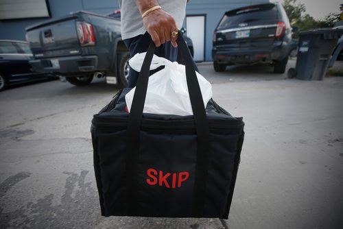 JOHN WOODS / WINNIPEG FREE PRESS
A driver from Skip The Dishes, the food delivery service, picks up some food at local Winnipeg restaurant Monday, July 30, 2018. The service provider is having labour issues.