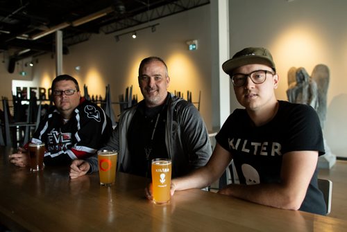ANDREW RYAN / WINNIPEG FREE PRESS  Steve Gauthier co-owner of Devil May Care brewery, left, Paul McMullan of Stone Angel brewery, centre, and Miguel Cloutier of Kilter brewery, right, and are all working together under the same roof in south Winnipeg. The three brewers are pictured at their bar on August 1, 2018.