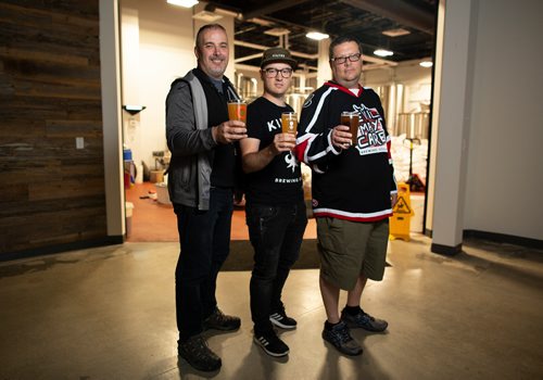 ANDREW RYAN / WINNIPEG FREE PRESS Paul McMullan of Stone Angel brewery, left, Miguel Cloutier of Kilter brewery, centre, and Steve Gauthier co-owner of Devil May Care brewery, are all working together under the same roof in south Winnipeg. The Three brewers are pictured in front of the brewing area on August 1, 2018.