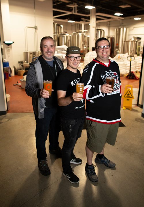 ANDREW RYAN / WINNIPEG FREE PRESS Paul McMullan of Stone Angel brewery, left, Miguel Cloutier of Kilter brewery, centre, and Steve Gauthier co-owner of Devil May Care brewery, are all working together under the same roof in south Winnipeg. The Three brewers are pictured in front of the brewing area on August 1, 2018.