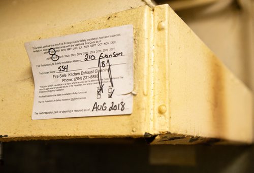 ANDREW RYAN / WINNIPEG FREE PRESS An inspection ticket indicating that the fire suppression system is due for inspection in August 2018 in The Madison supportive housing kitchen in Wolseley. Siloam Mission is worried that its aging kitchen equipment at Madison House will be too expensive to repair if anything were to break down and violate safety codes. The supportive housing facility is asking for funding to update the kitchen or else it fears it will be shut down. Shot on August 1, 2018.