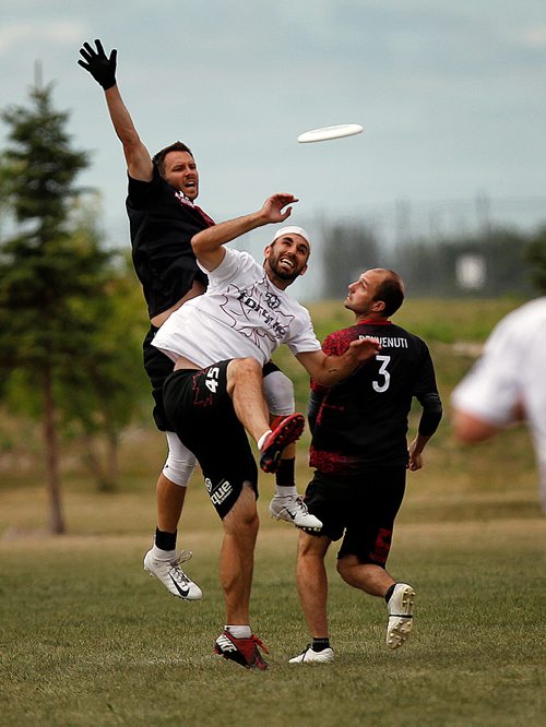 PHIL HOSSACK / WINNIPEG FREE PRESS -  Team Torque's #45 Yacine Bara goes up the middle for the flying disc flanked on both sides by team "Best Before" in Ultimate Play Wednesday. See Mike Sawatzky's story.  - July 31, 2018