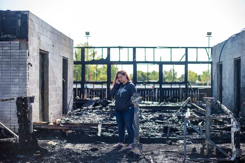MIKAELA MACKENZIE / WINNIPEG FREE PRESS
Nicole Woelke, president of the board, takes takes a phone call in the ruins of the fire-damaged Assiniboia West Recreation Centre in Winnipeg on Thursday, Aug. 2, 2018. 
Winnipeg Free Press 2018.