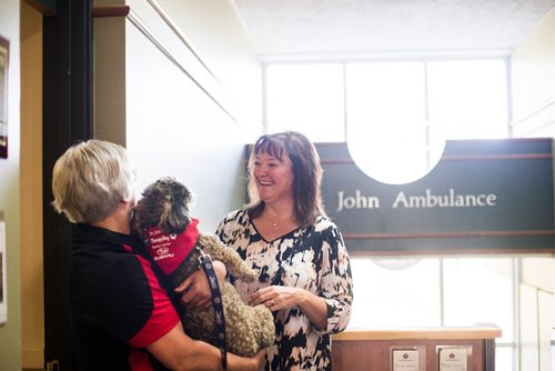 MIKAELA MACKENZIE / WINNIPEG FREE PRESS
Teresa Toutant, director of community services for St. John Ambulance, presents Donamae Hilton, and her dog, Mark-Cuss, with a bandana certifying Mark-cuss as a therapy dog for the organization in Winnipeg on Thursday, Aug. 2, 2018. 
Winnipeg Free Press 2018.