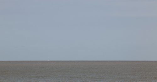 MIKE DEAL / WINNIPEG FREE PRESS
A lone sailboat on the horizon on Lake Winnipeg as seen from the Gimli beach Thursday afternoon.
180802 - Thursday, August 02, 2018.