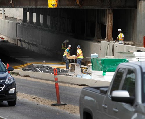 PHIL HOSSACK / WINNIPEG FREE PRESS -  Workers in Northbound lanes of the McPhillips Street underpass Thursday. See story.  - August 2, 2018
