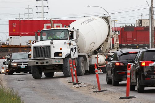 PHIL HOSSACK / WINNIPEG FREE PRESS -  A concrete truck works its way into traffic at the McPhillips Street underpass Thursday. See story.  - August 2, 2018