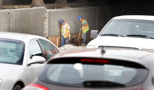 PHIL HOSSACK / WINNIPEG FREE PRESS -  Workers under the McPhillips Street underpass Thursday. See story.  - August 2, 2018