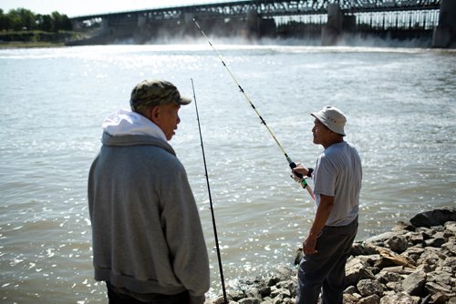 ANDREW RYAN / WINNIPEG FREE PRESS Anglers, Romualdo Sison, right, and Rollando Guemo fish along the Red River just down stream from the Lockport Dam on August 3, 2018. Judy Robertson, past president of the Wildlife Haven Rehabilitation centre, advocated for monofilament (fishing line) recycling boxes at the Lockport Lock and Dam after seeing the same program in Florida.