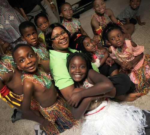 PHIL HOSSACK / WINNIPEG FREE PRESS -  Florence Okwudili poses with members of the Umunna Igbo Association Dancers in a small room in her basement where they rehearse for their Folklorama apperances. . See Melissa Martin's story.  - August 3, 2018