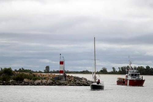 TREVOR HAGAN / WINNIPEG FREE PRESS
A sailboat and the coast guard enter the Gimli Harbour on Lake Winnipeg during the Icelandic Festival in Gimli, Sunday, August 5, 2018.