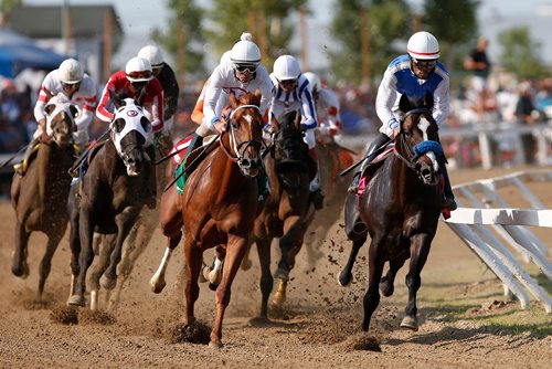 JOHN WOODS / WINNIPEG FREE PRESS
Chavion Chow riding Eaglebine, right, leads into the first bend in the 70th running of the Manitoba Derby at Assiniboia Downs Monday, August 6, 2018.