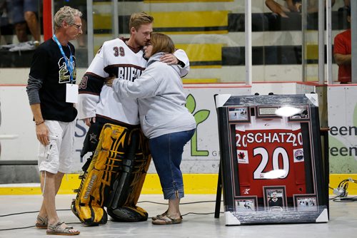 JOHN WOODS / WINNIPEG FREE PRESS
Bonnie and Kelly Schatz embrace their son Brandon at a ceremony to honour their son and brother Logan, who was killed in the Humboldt Broncos crash, at the opening of the Canadian Ball Hockey Association Nationals at MTS Iceplex Monday, August 6, 2018.