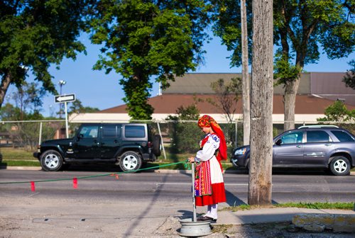 MIKAELA MACKENZIE / WINNIPEG FREE PRESS
Viana Vassallo, eight, plays in her costume outside of the Casa do Minho Portuguese Pavilion in Winnipeg on Monday, Aug. 6, 2018. 
Winnipeg Free Press 2018.