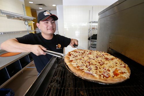 JOHN WOODS / WINNIPEG FREE PRESS
Cheng Tang, Panago Pizza franchisee, makes a pizza in his take out pizza place Tuesday, August 7, 2018. Tang is opening up his own pizza joint with an asian flair, Pizza Gong, at the end of August after Panago contacted him notifying the Winnipeg franchisees that they will no longer be operating in the city.