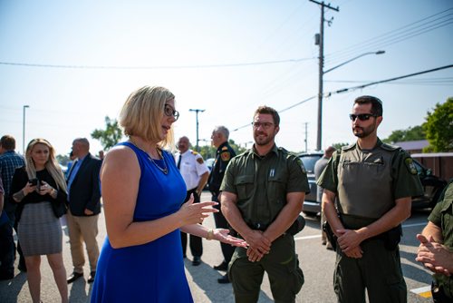 ANDREW RYAN / WINNIPEG FREE PRESS Sustainable Development Minister Rochelle Squires speaks to Selkirk conservation officers Kevin Doerksen, left, and Ryan Kopchuk at a press event announcing new public safety communications devices at the West St. Paul Fire Hall on August 8, 2018.