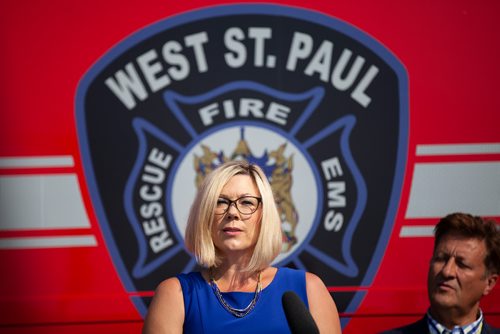 ANDREW RYAN / WINNIPEG FREE PRESS Sustainable Development Minister Rochelle Squires speaks at a press event, with Infrastructure minister Ron Schuler behind her, announcing new public safety communications devices at the West St. Paul Fire Hall on August 8, 2018.