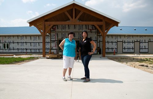 ANDREW RYAN / WINNIPEG FREE PRESS Judy Robertson, left, the former president of the Wildlife Haven and Rehabilitation Centre, and executive director Zoé Nakata, pose for a portrait in front of the centre's new entrance. The Wildlife Haven and Rehabilitation Centre is hoping to soon be moving into the $3 million facility boasting an interactive visitor centre, animal viewing area, and many other improvements over their current location south of Winnipeg. Shot on August 8, 2018.