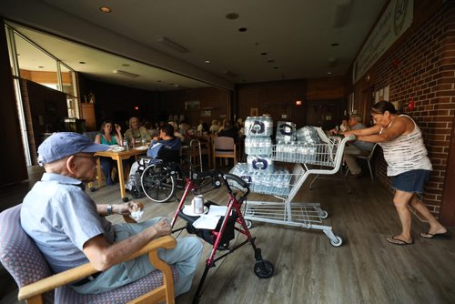 RUTH BONNEVILLE / WINNIPEG FREE PRESS


Residents at St Josaphat Selo-Villa  low-income housing at 114 McGregor St. bear the heat and darkness after power has been out in their block since Monday evening. 

One of the residences volunteers her time pushing a shopping cart of bottled water into their darkened dining room to offer to people living in the block Wednesday.  The residences were offered Subway sandwiches and pop for dinner due to the power outage.  

See Erik's story.  

August 8th, 2018