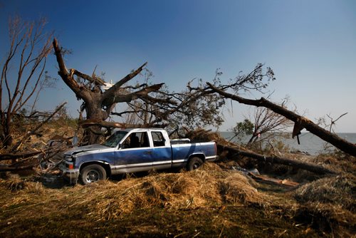 PHIL HOSSACK / WINNIPEG FREE PRESS -   A battered pick up rests at the bast of a storm torn tree at Margaret Bruce Beach on Lake Manitoba Wednesday.  See story. - August 8, 2018