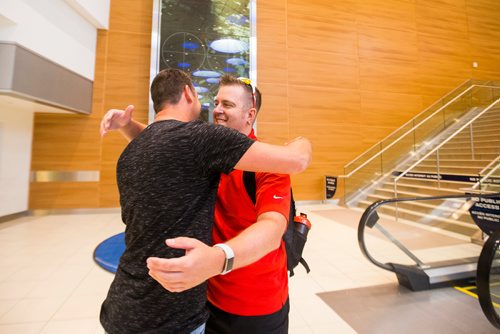 MIKAELA MACKENZIE / WINNIPEG FREE PRESS
Jamie Benzelock (right) meets his stem cell donor, Marco Kiunka, for the first time at the airport in Winnipeg on Thursday, Aug. 9, 2018. 
Winnipeg Free Press 2018.