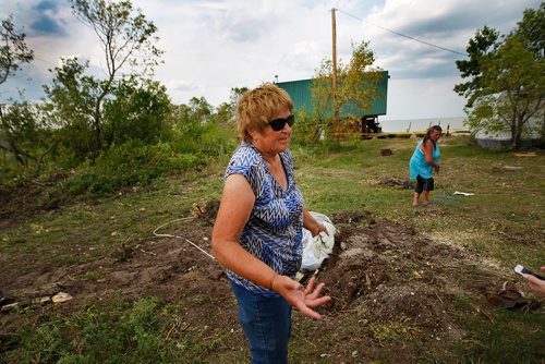 PHIL HOSSACK / WINNIPEG FREE PRESS -Crystal Bruce shrugs her shoulders and carry's on cleaning her campground with help from a camper. She and her husband spent years cleaning Margaret Bruce Beach after 2011's flooding steered their way to protect Winnipeg from the rising Assiniboine River.  See story. - August 7, 2018