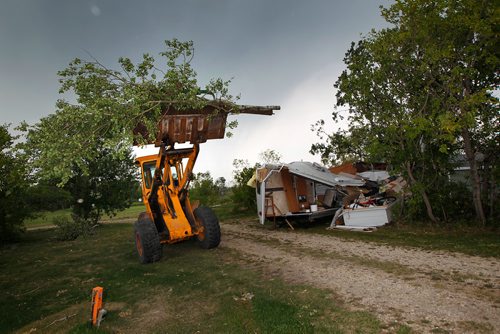 PHIL HOSSACK / WINNIPEG FREE PRESS -   Jimmy Bruce uses a loader to clear debris from the Margaret Bruce Beach and campground Tuesday after a tornado ripped through the Alonsa Manitoba area Friday. See story. - August 7, 2018