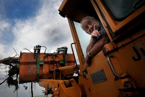 PHIL HOSSACK / WINNIPEG FREE PRESS -   Jimmy Bruce points to where the tornado came from last Friday from the cab of his loader as he removes debris from Margaret Bruce Beach and campground Tuesday. A tornado ripped through the Alonsa Manitoba area Friday. See Melissa Martin story. - August 7, 2018
