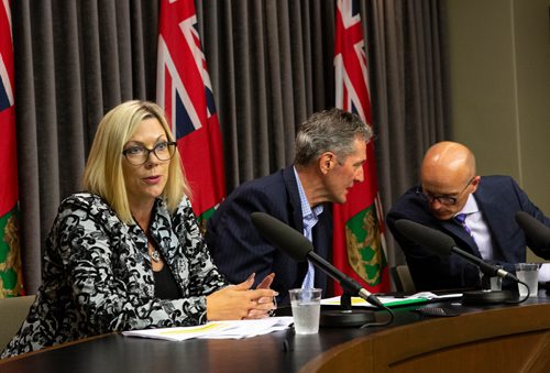 ANDREW RYAN / WINNIPEG FREE PRESS Manitoba Premier Brian Pallister, centre, and Fred Meier, clerk of the executive council share words as Sustainable Development Minister Rochelle Squires discusses a recent report detailing workplace sexual harassment and measures taken to mitigate it in government at the Manitoba Legislature building press room on August 9, 2018.