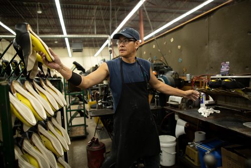 ANDREW RYAN / WINNIPEG FREE PRESS Paul Marcelino, reaches for a military officer's shoe at the Canada West Boot factory on August 9, 2018.