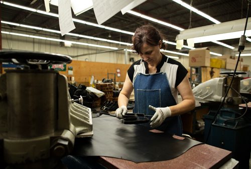 ANDREW RYAN / WINNIPEG FREE PRESS Eva Skovrlj places a cookie-cutter like stencil over top of a sheet of leather to be punched out for the design of Canada West Boots. Seen on the assembly line of the company's manufacturing centre on August 9, 2018.
