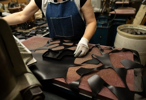 ANDREW RYAN / WINNIPEG FREE PRESS Eva Skovrlj places a cookie-cutter like stencil over top of a sheet of leather to be punched out for the design of Canada West Boots. Seen on the assembly line of the company's manufacturing centre on August 9, 2018.