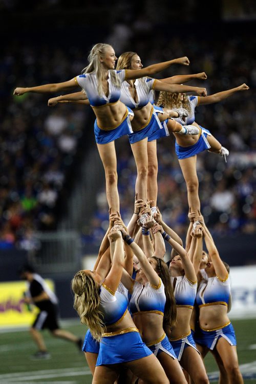 PHIL HOSSACK / WINNIPEG FREE PRESS - A flying Winnipeg Blue Bomber dance team Friday night at Investor's Group Stadium in Winnipeg. See story. - August 10, 2018