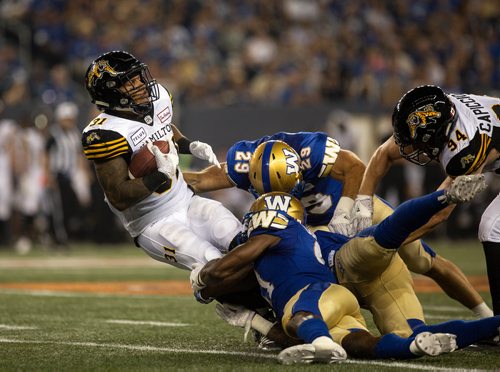 ANDREW RYAN / WINNIPEG FREE PRESS Hamilton Tiger-Cats' Sean Thomas Erlington (31) is taken down by Bombers defence in game action on August 10, 2018.