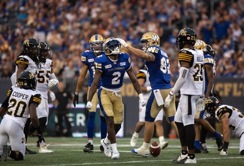ANDREW RYAN / WINNIPEG FREE PRESS Winnipeg Blue Bombers' Drew Wolitarsky (82) and Kenbrell Thompkins (2) celebrate getting yards against the Hamilton Tigercats in game action on August 10, 2018.