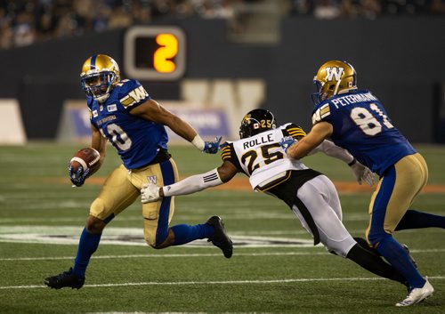 ANDREW RYAN / WINNIPEG FREE PRESS Nic Demski (10) evades a tackle from Hamilton Tiger-Cats' Jumal Rolle (25) in game action on August 10, 2018.