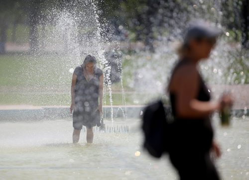 TREVOR HAGAN / WINNIPEG FREE PRESS
A woman cools off in the fountain on Memorial Boulevard, Sunday, August 12, 2018.