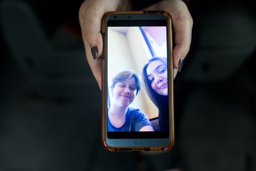 MIKAELA MACKENZIE / WINNIPEG FREE PRESS
Hannah Harris shows more recent family photos of Ben Harris and his girlfriend, Akita Mcrae, on her phone in the R.M. of St. Andrews on Monday, Aug. 13, 2018. 
Winnipeg Free Press 2018.