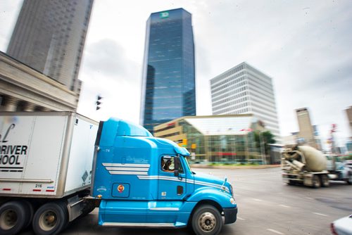 MIKAELA MACKENZIE / WINNIPEG FREE PRESS
Trucks pass through Portage and Main in Winnipeg on Monday, Aug. 13, 2018. 
Winnipeg Free Press 2018.