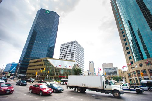 MIKAELA MACKENZIE / WINNIPEG FREE PRESS
Trucks pass through Portage and Main in Winnipeg on Monday, Aug. 13, 2018. 
Winnipeg Free Press 2018.