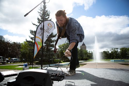 ANDREW RYAN / WINNIPEG FREE PRESS Noah Derksen grabs his harmonica before he performs at the launch of Manyfest at memorial park on August 14, 2018.